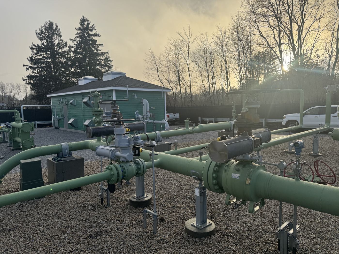 Actuated ball valves on green station piping at a gas regulator station